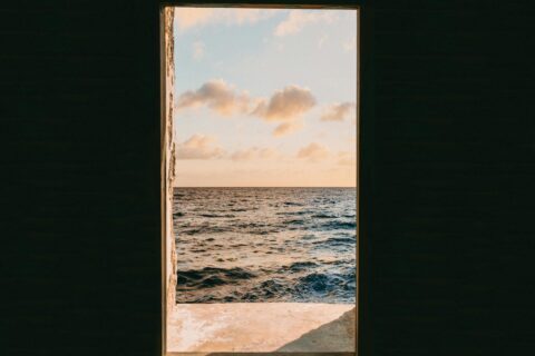 window view of sea during golden hour